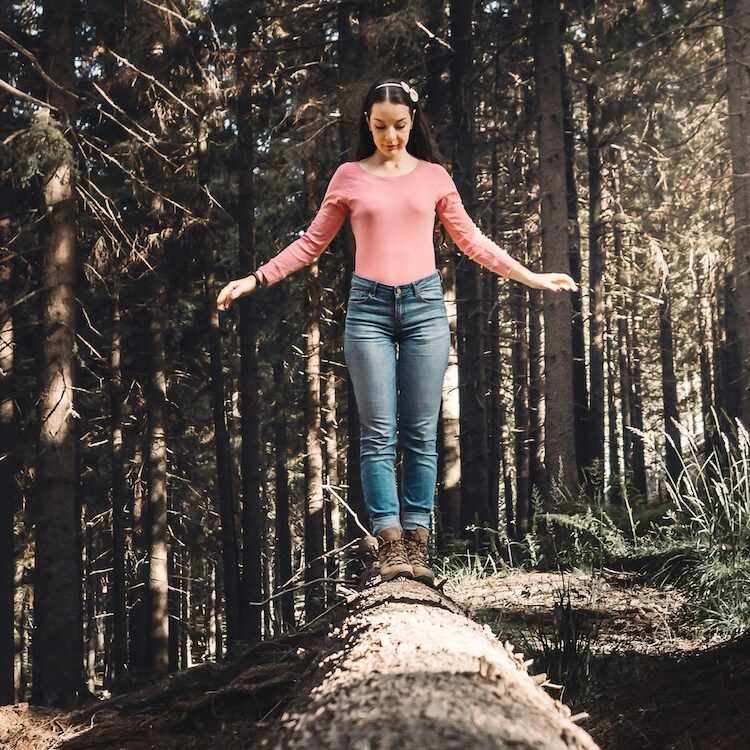 Woman balancing on a log with confidence. Sheila Van tol Counselling 2025